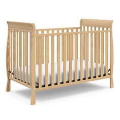 a wooden crib with white sheets on the bottom and side rails, against a white background