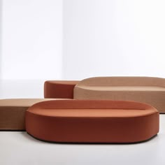 three different colored couches sitting next to each other