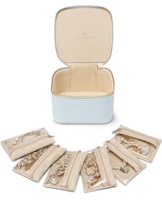 six pieces of jewelry in a white case