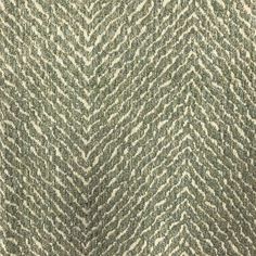 an upholstered fabric with green and white herringbones on the back side