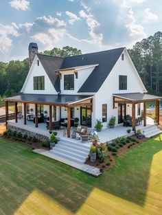 a large white house sitting on top of a lush green field