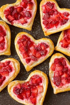 heart shaped strawberry shortbreads on a plate with strawberries