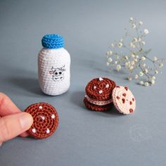 crocheted cookies and milk bottle on grey surface