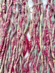 several strands of pink, green and white beads