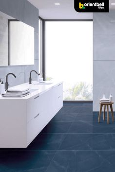 a bathroom with blue flooring and two sinks