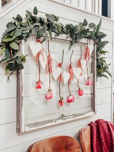 an old window is decorated with flowers and greenery for valentine's day decor