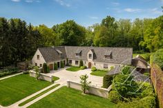 an aerial view of a large house with lots of trees and grass in the yard