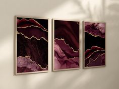 three abstract paintings hang on the wall