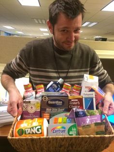 a man holding a basket full of food in an office cubicle with the caption under him