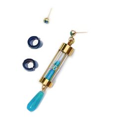 a pair of earrings with blue beads and gold tone fittings on the end of each ear