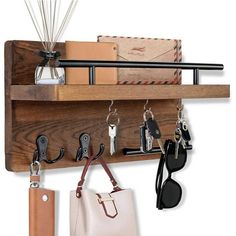 a wooden shelf with keys, wallets and other items hanging from it's hooks