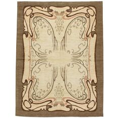 a beige and brown rug with an intricate design