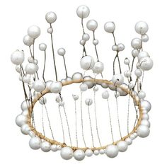 a tiara with white balls on it