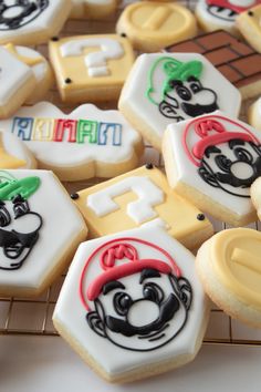 some decorated cookies are sitting on a cooling rack