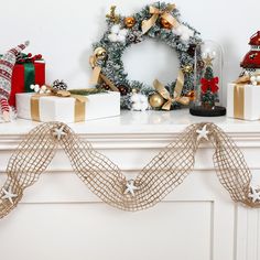 a mantle with presents and christmas decorations on it