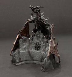 a statue of a dragon sitting on top of a rock