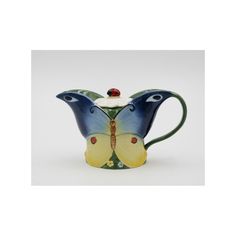 a blue and yellow butterfly shaped tea pot