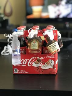 a coca - cola box with six bottles in it