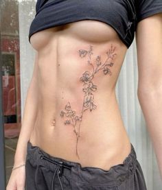 a woman with a flower tattoo on her stomach