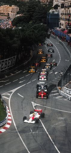 a group of cars driving down a race track