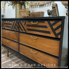 a black and brown dresser with gold handles