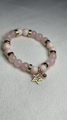 Light Pink Bracelet with Gold accents, Star charm, and light pink and gold gem! Strong, Stretchy, and Durable 7 in or 17.78 cm round Pretty bracelet for any occasion for any day Charm For Bracelet, Light Pink Bracelet, Pink Rose Quartz Round Stretch Bracelet, Pink Rose Quartz Stretch Bracelet, Trendy Pink Jewelry With Star Charm, Pink Star Charm Jewelry, Trendy Pink Star Bracelet, Elegant Pink Star-shaped Jewelry, Trendy Pink Star-shaped Jewelry