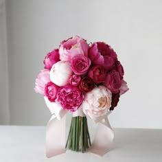 a bouquet of pink and white flowers on a table