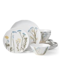 a set of dishes with flowers painted on them