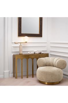 a chair and table in a room with a mirror on the wall above it,