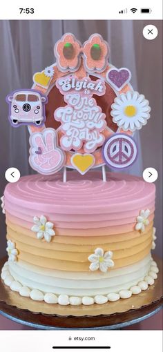 an image of a cake decorated with flowers and peace signs on it's top