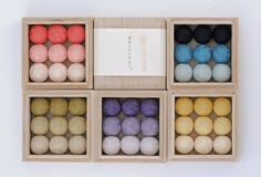 six wooden boxes filled with different colored balls