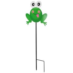 a green frog standing on top of a metal pole with its tongue out and eyes wide open