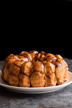 a bundt cake sitting on top of a white plate with caramel glaze