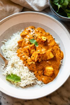 a white bowl filled with rice and chicken curry