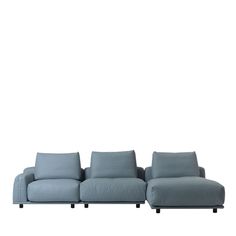 a blue couch sitting on top of a white floor