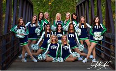 a group of cheerleaders posing on a bridge