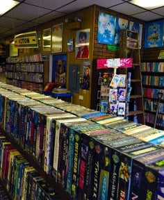 there are many books on the shelves in this store that is filled with cds and dvds