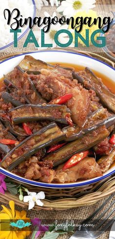 a bowl filled with meat and vegetables on top of a table