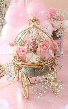 there is a small birdcage with flowers in it