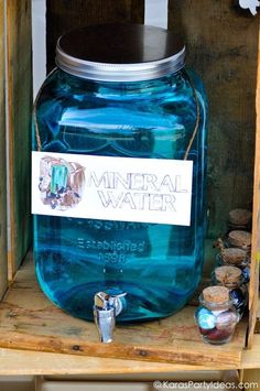 a blue mason jar sitting on top of a wooden crate