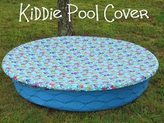 the kiddie pool cover is shown in front of a tree and grassy area with grass