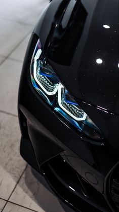 the front end of a black sports car