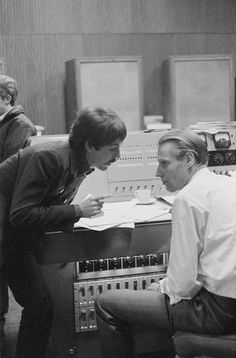 an old photo of two men sitting in front of a computer screen with the caption you can share this post with friends