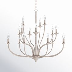 a white chandelier hanging from a ceiling