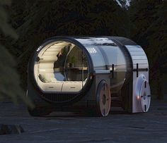 a futuristic vehicle is parked in front of some trees