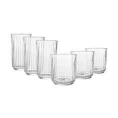 set of four clear glass tumblers with no lids on the bottom and one is empty