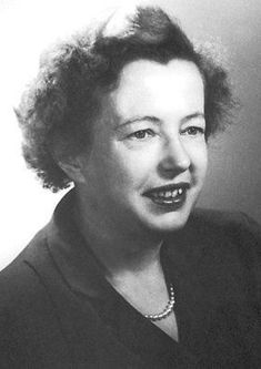 an old black and white photo of a woman smiling