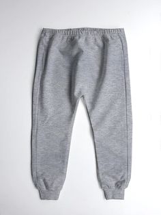 a pair of grey sweatpants sitting on top of a white surface