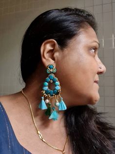 "Handmade statement teal green and turquoise smaller version stunning earrings. Made of handmade fabric cabochons in teal green and turquoise cotton fabric genuinely looks awesome. These handmade earrings are statement indeed. An ideal evening and party jewellery. The earrings measure approx. 3.30\" inclusive of the fringes and 1.75\" wide. This earring is a smaller version of my most popular oversized earring in the store. At Carnation jewellery, each piece is handmade and handcrafted in India, Turquoise Chandbali Earrings With Latkans, Festive Green Dangle Chandelier Earrings, Green Danglers With Latkans, Handmade Green Tassel Earrings For Party, Handmade Blue Chandelier Earrings, Bohemian Green Chandelier Earrings For Party, Turquoise Chandbali Jewelry With Latkans, Blue Bohemian Earrings With Latkans, Bohemian Turquoise Dangle Earrings