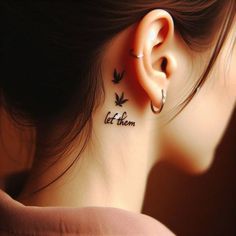 a woman's ear with the words let them tattoo on it